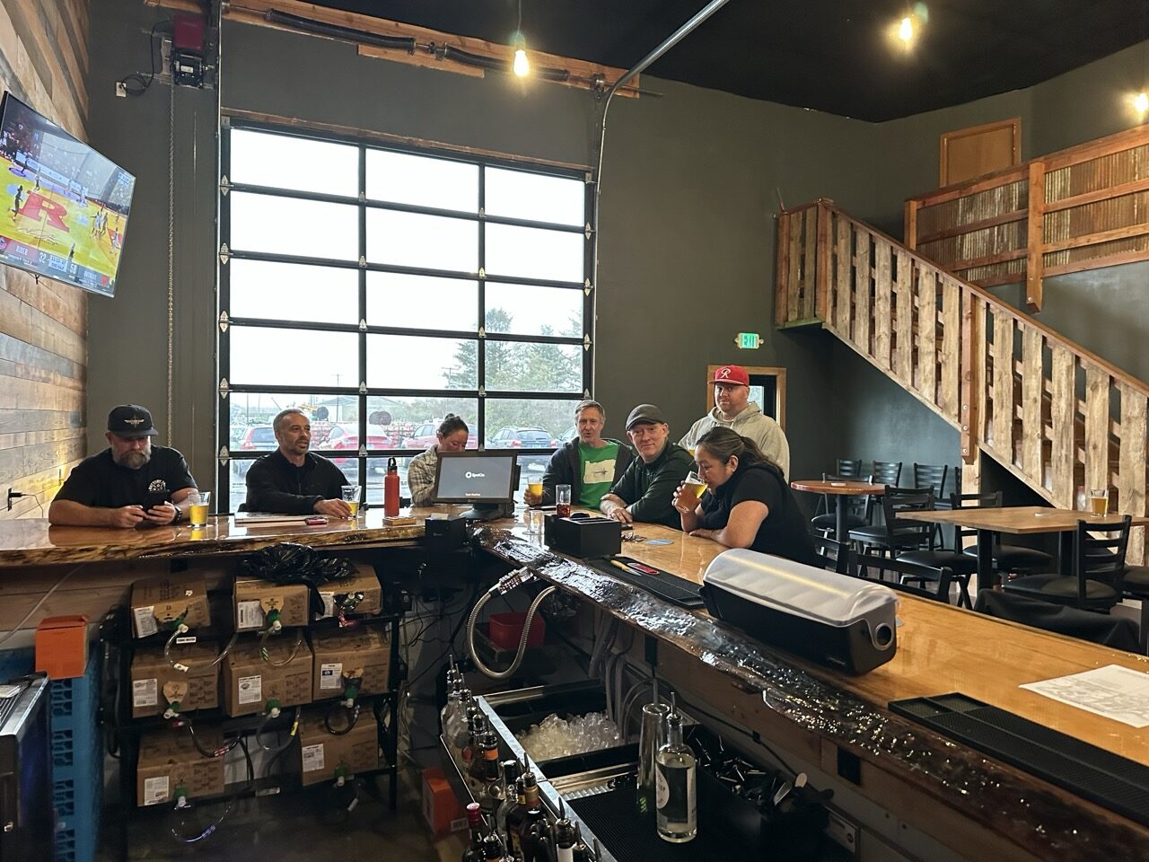 Friends gathered at the Battery 245 taproom bar on a game day