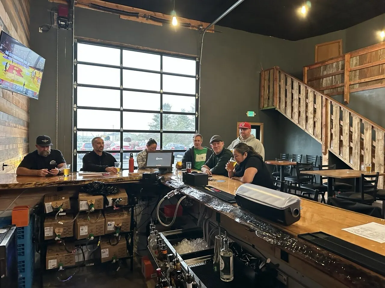 Friends gathered at the Battery 245 taproom bar on a game day